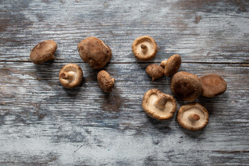 raw shiitake mushrooms on a wooden board