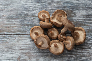 raw shiitake mushrooms on a wooden board