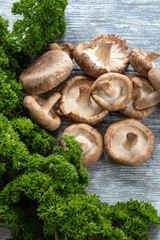 Raw shiitake mushrooms with fresh parsley
