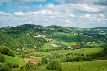 springtime panorama of the hills of oltrepo pavese, vinery area in italy (lombardy region) at the borders with piedmont and emilia romagna. it's famous for valuables wines, mainly sparkling wines.