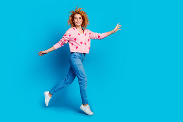 Full body photo of pretty young girl running excited wear trendy pink outfit isolated on blue color background