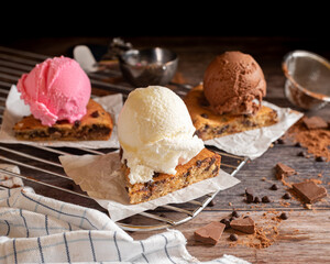 Closeup of chocolate chip cookies topped with ice cream