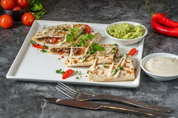 Closeup of quesadilla with sauce on a table
