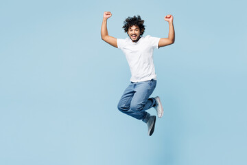 Full body overjoyed young fun happy Indian man he wear white t-shirt casual clothes jump high do...