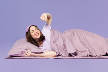 Side view young calm woman wear pyjamas jam sleep eye mask rest relax at home lay down on bed...