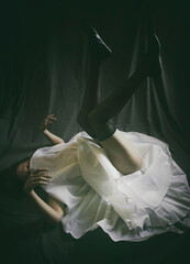 dancer lying on the floor with her legs up in a desolate attitude © livcool