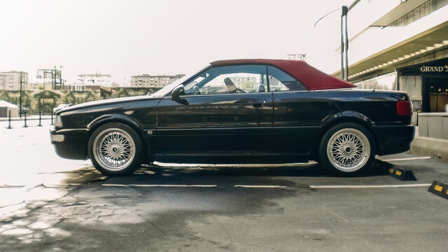 car Audi Cabriolet with soft-top parked at the city street