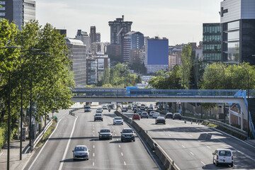 Urban entrance road to Madrid and a large pedestrian walkway over the road