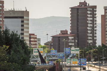 Urban entrance road to Madrid with several lanes in each direction and large signs indicating directions