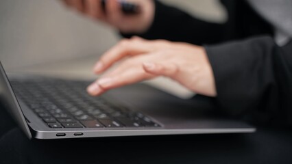 Caucasian beautiful girl is smiling, typing, working, and looks focused. Remote work digital...