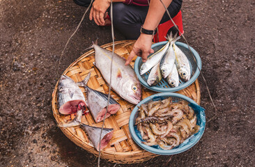 selling shrimp and fish at an asian street market