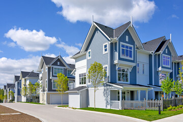 A perfect neighborhood. Brand new townhouses district on blue sky background
