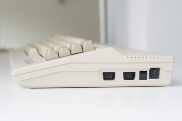 A side view of a vintage computer with visible ports, illuminated by daylight. Perfect for...