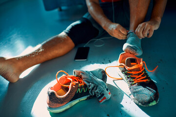 Man taking off dirty shoes at home after workout