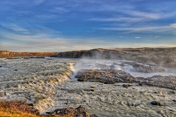 Waterfall in Iceland in Summer with Sun and Blue Sky