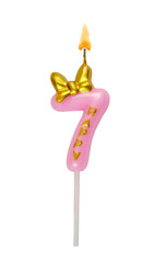 Pink birthday candle with gold bow isolated on white background. Number 7.	