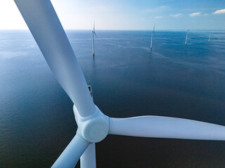 A single wind turbine stands tall in the middle of the vast ocean, harnessing the power of the wind...