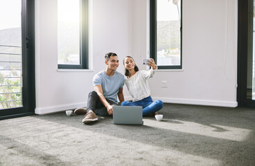 Selfie, happy or couple on laptop in new house in real estate, property investment or buying...