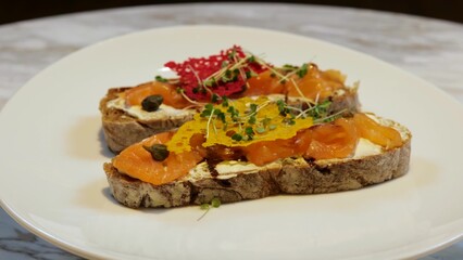 Close up of bruschetta with sliced salted salmon. Healthy and wholesome food. Serving food in a restaurant. 