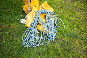 blue climbing rope on green grass .  background image of the rope for active sports.