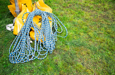 Blue climbing rope on green grass .  Background image of the rope for active sports. Copy space
