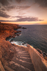 Fototapeta premium Stairs to the ocean at the sunset