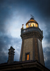 Aviles lighthouse at night with the light on and from very close. Asturias, Spain.