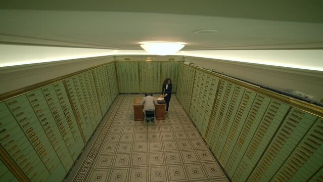 A man and a woman are in a room filled with lockers