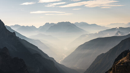 Mountainous valley with fog at dawn