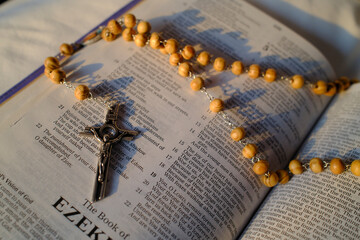 Rosary on an open bible. The book of Ezekiel.