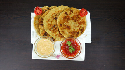 Aloo Paratha, the Quintessential Indian Comfort Food, Filled with Spiced Potatoes, Served Fresh and Hot, Embodies Generations of Culinary Tradition is perfect for Indulgent Breakfasts or Hearty Meals