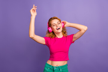 Naklejka premium Photo of lovely cheerful glad woman wear trendy pink clothes enjoy music isolated on purple color background