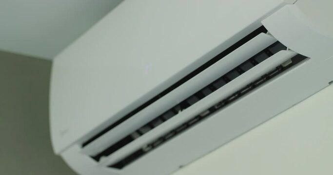 Air conditioner operation, flow louvers move up and down, distributing the air flow