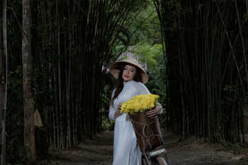 woman with in Vietnam traditional with  yellow flower.