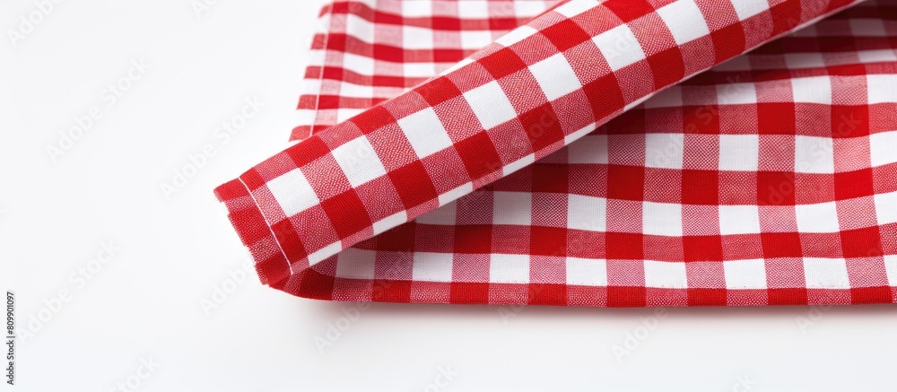 Leinwandbilder a checkered textile napkin is displayed on a white background leaving ample copy space in the image