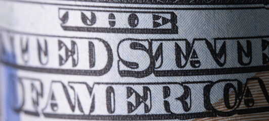 Macro image with description: THE UNITED STATE OF AMERICA on one hundred US Dollar bill. High...