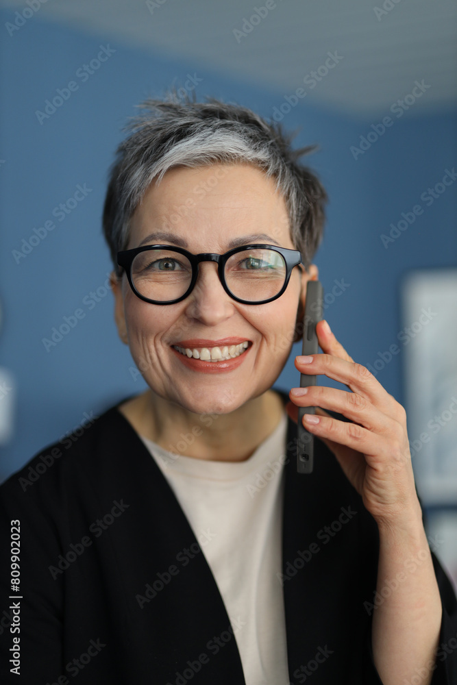 Sticker A positive senior businesswoman smiles confidently, radiating happiness and success in her portrait.