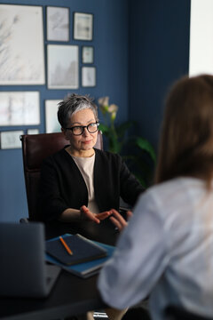 Teamwork in the workplace: a businesswoman and her colleague have a professional discussion in the office.