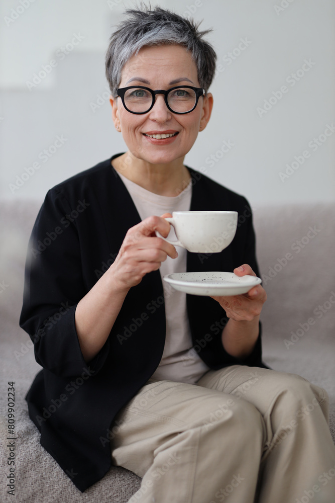 Sticker a happy woman enjoys her morning coffee at home, savoring the moment of relaxation and joy.