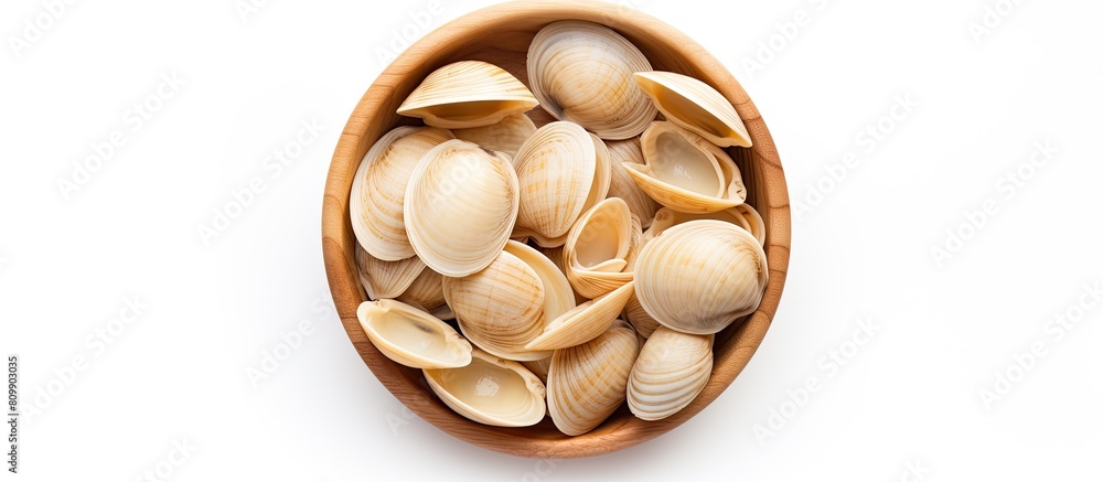 Poster top view of a wooden bowl filled with raw striped shell pasta known as conchiglie rigate placed on a