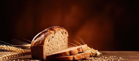 Copy space image of whole wheat bread on a brown background - obrazy, fototapety, plakaty