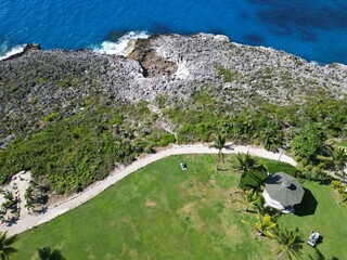 Pedro St James Savannah Grand Cayman Islands birds eye aerial perspective view lush greenery and blue azure Caribbean sea ironshore water 