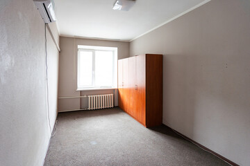 Empty room with all white walls and parquet floor. Nobody inside the room.