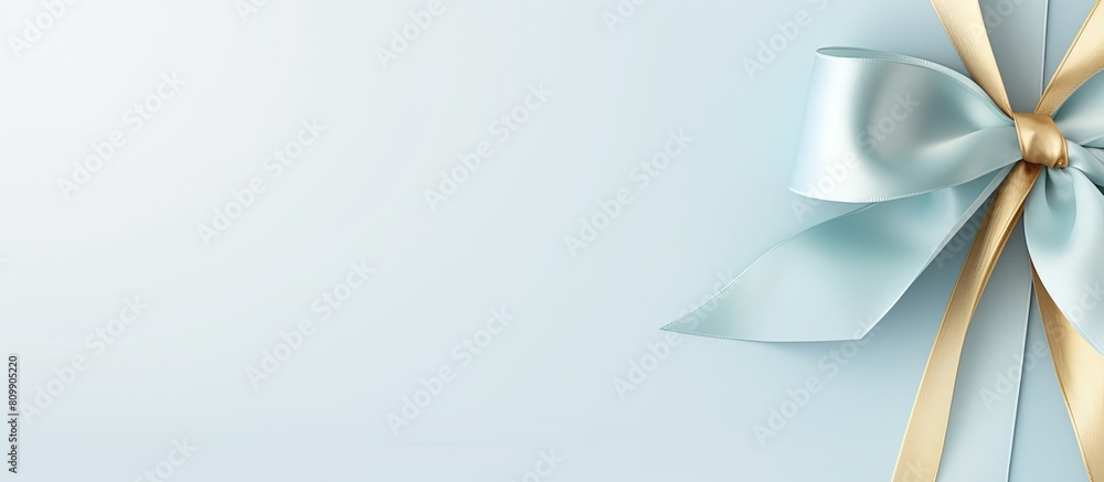 Poster light blue background adorned with a beautiful golden ribbon leaving ample copy space for text