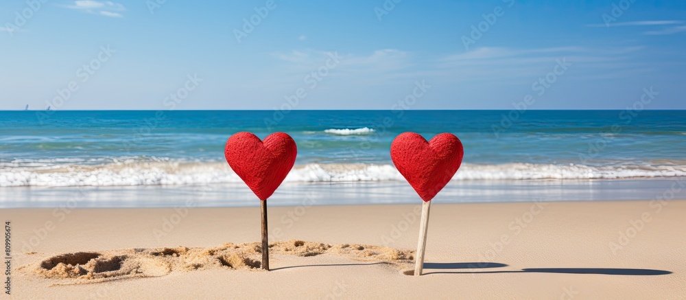 Poster two heart shaped cutouts in vibrant red color are attached to the tops of sticks creating a lovely a