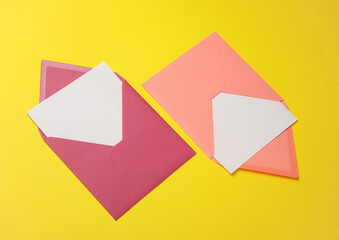 Pink envelopes with white blank letters on a yellow background. Creative layout