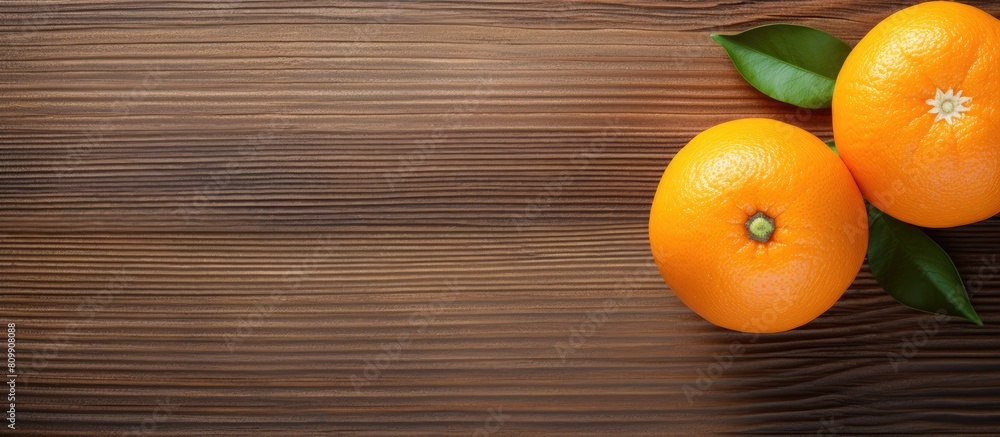 Poster Top view of a fresh orange placed on a textured wooden surface creating a visually appealing composition with copy space for an image