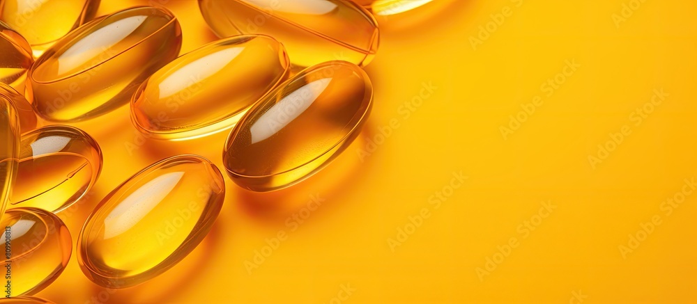 Aufkleber A high resolution close up image of numerous Omega 3 capsules placed on a yellow background portraying a health care concept There is ample copy space in the image