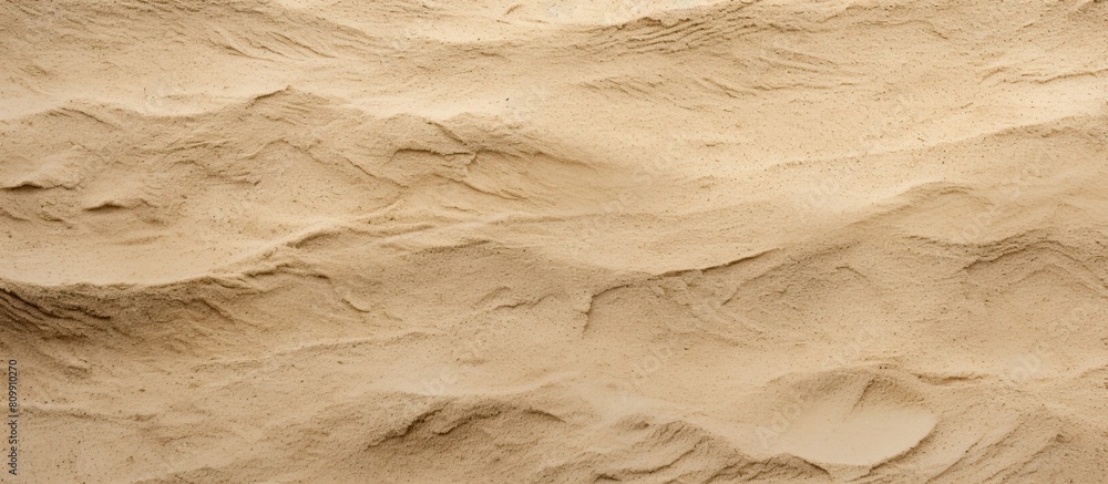 Poster a background image featuring a close up shot of a textured sand floor ideal for use as a copy space 