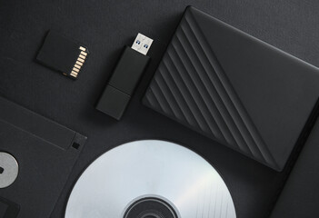 Outdated and modern digital storage media on black background